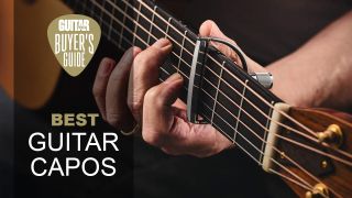 Close up of a capo on an acoustic guitar 