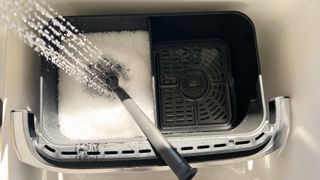 Ninja Foodi DualZone FlexBasket being washed in sink