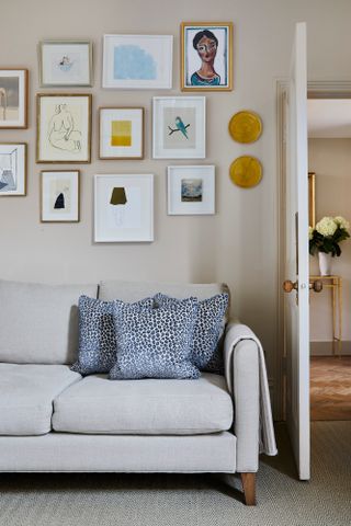 Neutral living room with beige sofa and gallery wall