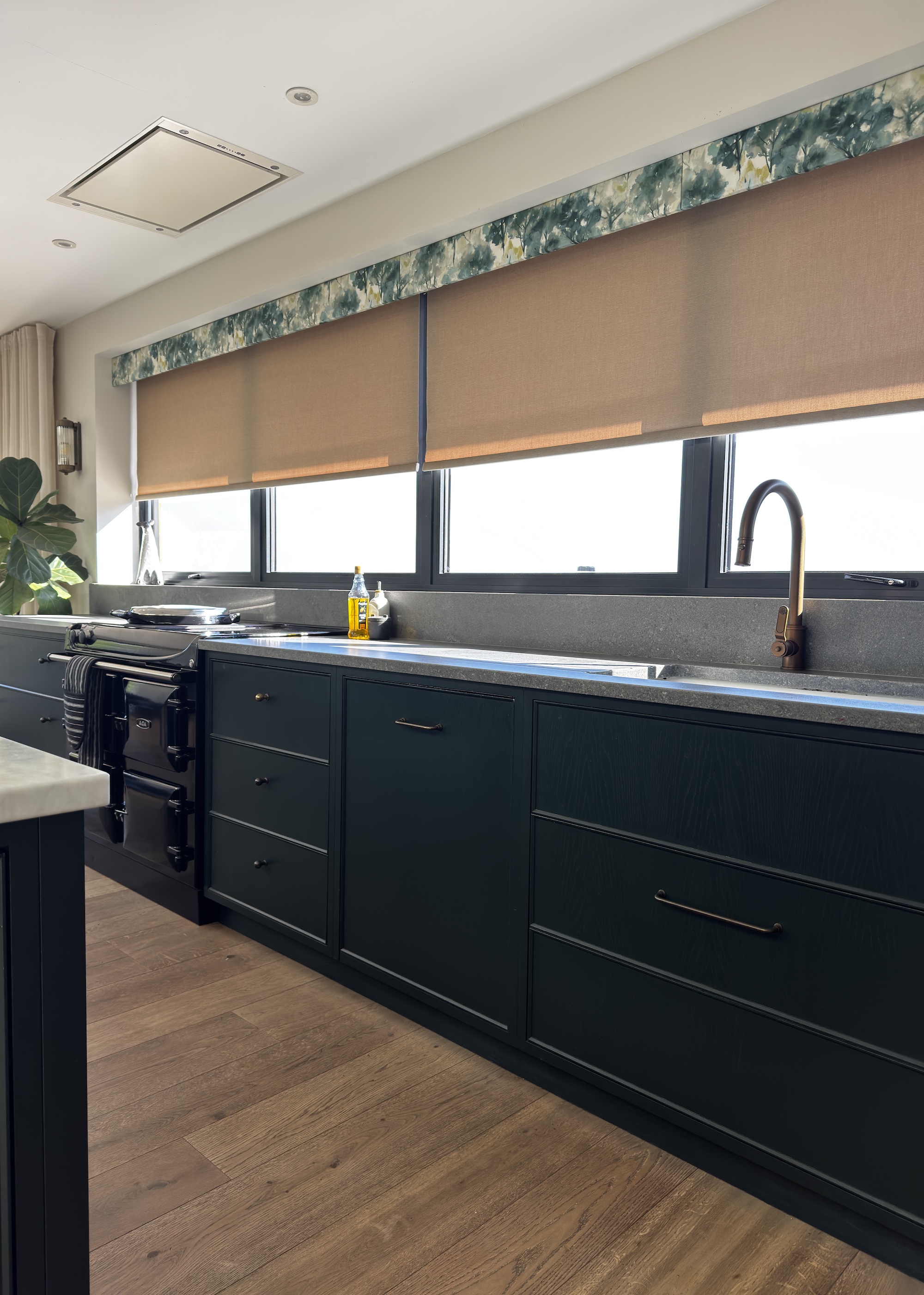 green kitchen with wood floors and blinds