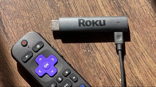 Roku Streaming Stick 4K (2021) pictured on a wooden surface