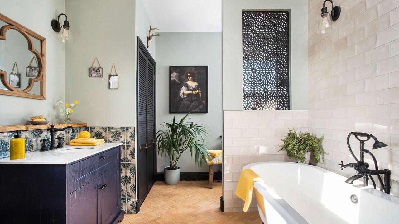 Moroccan inspired small bathroom with terracotta floor tiles and decorative tiled walls