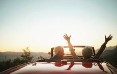 Couple driving in a convertible