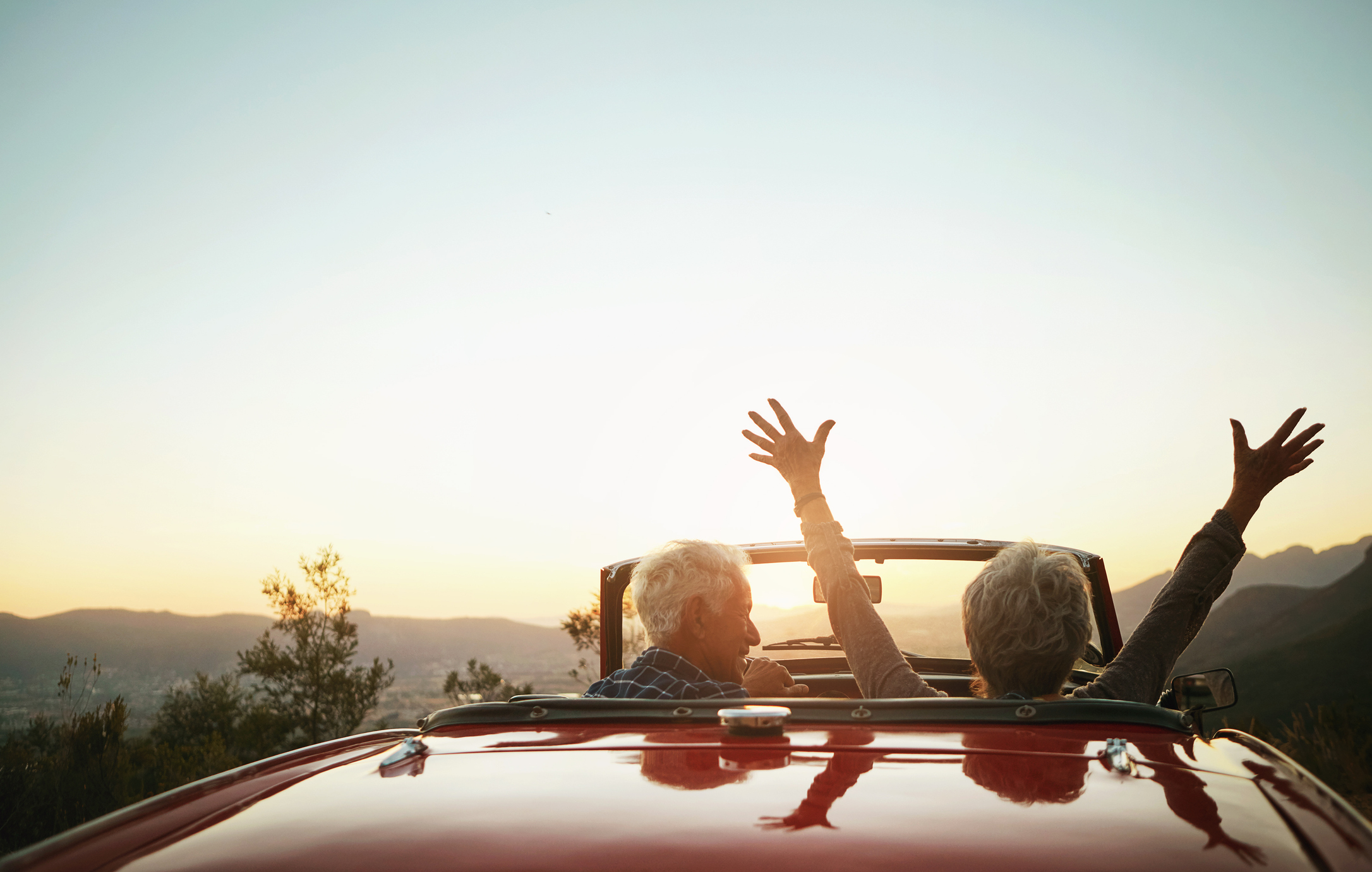 Couple driving in a convertible 