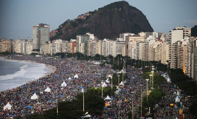 Pilgrims and residents camp out on Copacabana Beach at dawn while awaiting Pope Francis&amp;#039; final Mass on his trip to Brazil on July 28, 2013 in Rio de Janeiro, Brazil. A reported crowd of three