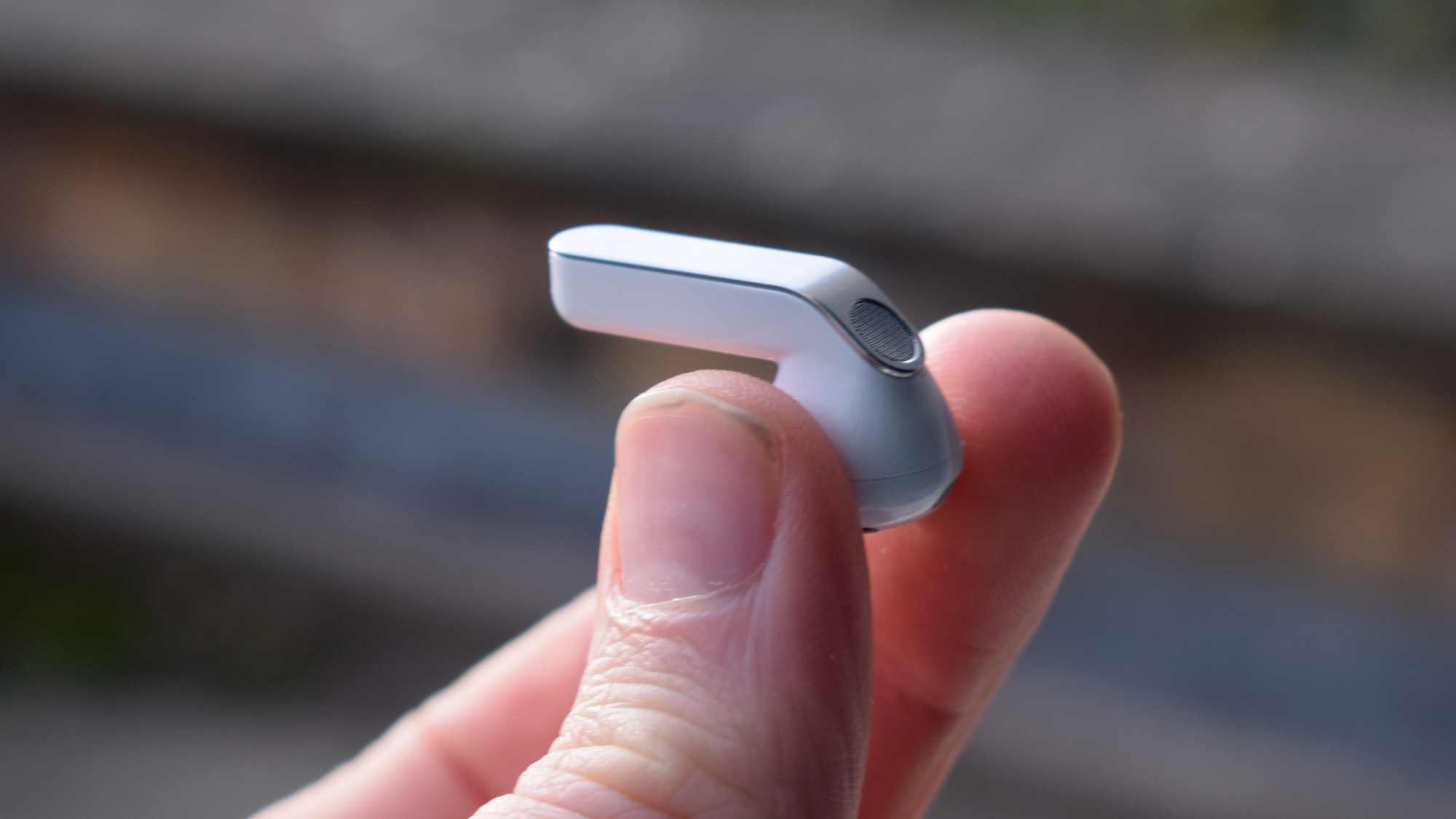 The Samsung Galaxy Buds 4 earbud in a man's hand.