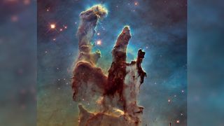 The central third of the image is filled with a towering structure of gas called the Eagle Nebula. In the background bright stars shine through the dust.