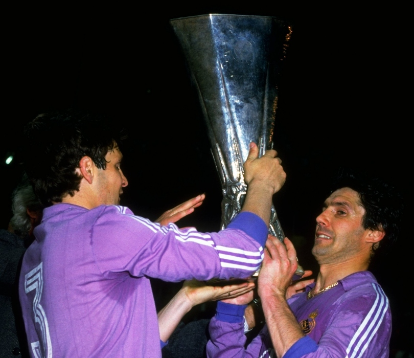 Real Madrid pair Jose Antonio Camacho and Santillana celebrate with the UEFA Cup trophy after victory in the final against FC Köln.