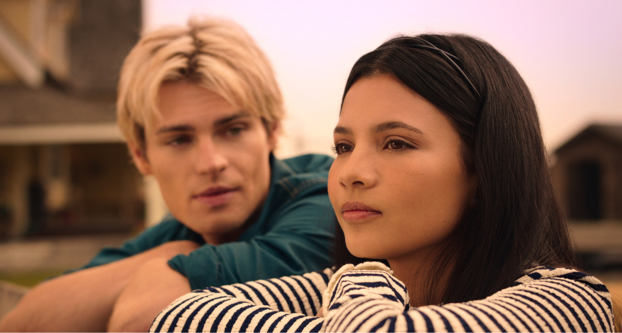 noah lalonde as cole walter looking at nikki rodriguez as jackie howard as they lean on a fence in my life with the walter boys