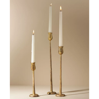 tall gold candlesticks with a rustic design