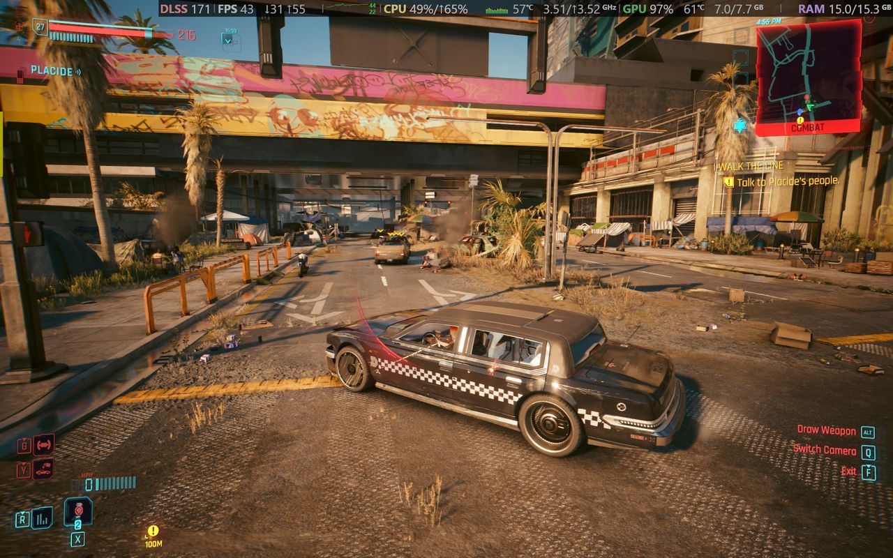 Cyberpunk 2077 gameplay screenshot showing car driving mechanics and UI elements running on an Alienware 15 laptop