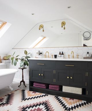 loft bathroom with large mirror fitted on wall above black double vanity unit