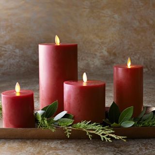Premium Flameless Wax Pillar Candles against a brown marble background.