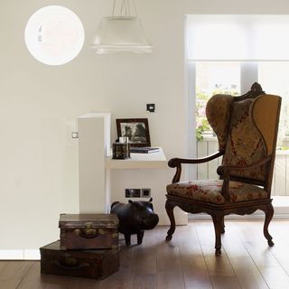 Study area in white sitting room with antique trunks