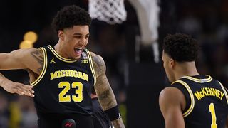 Yaxel Lendeborg #23 and Trey McKenney #1 of the Michigan Wolverines react while playing against the Arizona Wildcats during the first half in the Final Four of the 2026 NCAA Men's Basketball Tournament at Lucas Oil Stadium on April 04, 2026 in Indianapolis, Indiana. 