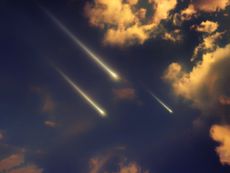 Three fireballs falling from the sky at sunset.