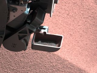 A sample of Mars dirt is shown in the scoop instrument of NASA's Curiosity Mars rover. The rover began using its scoop in October 2012, and this photo was taken by Curiosity's right Mast Camera (Mastcam-100) on Oct. 10, 2012, the 64th sol, or Martian day, of operations.