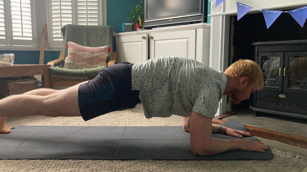 Fit &amp; Well fitness writer Harry Bullmore performing a plank up and down
