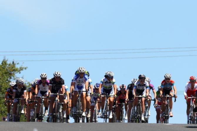 The bunch, spread across the road, almost half a lap behind Cromwell