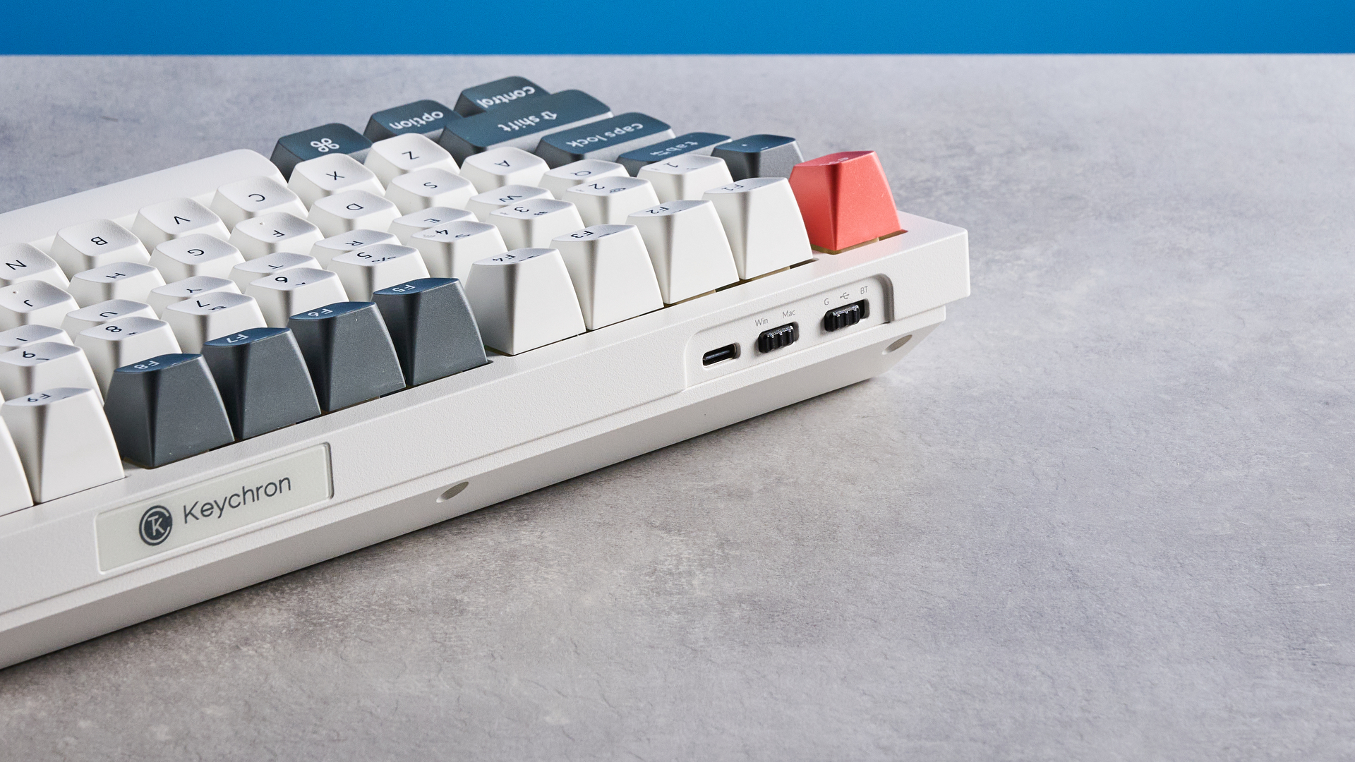 Keychron Q3 Ultra 8K photographed on a grey table in front of a blue background