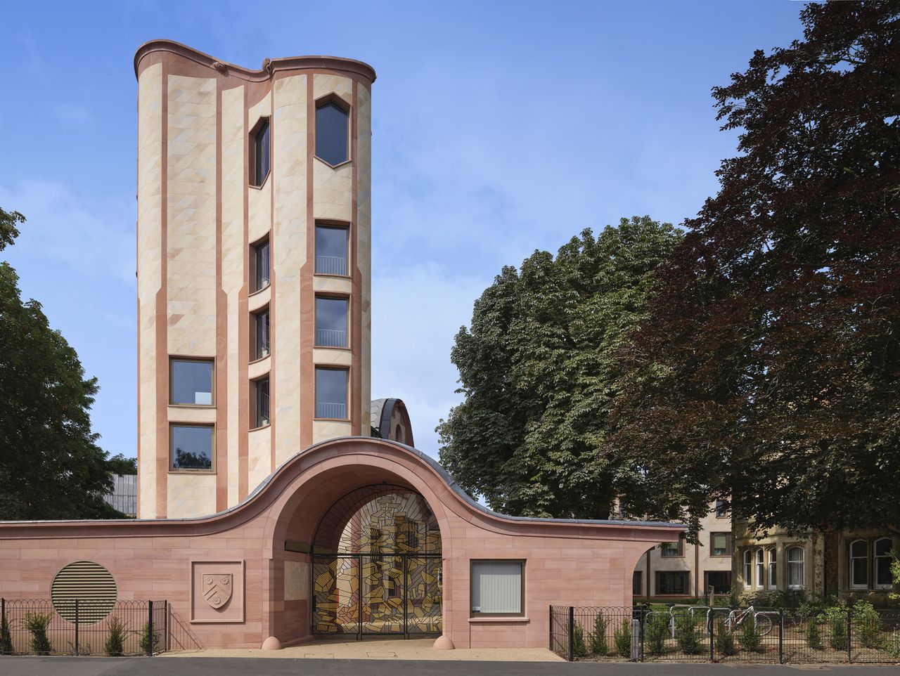 Gradel Quadrangles in Oxford with its pink hued exterior and curved shapes and gargoyles