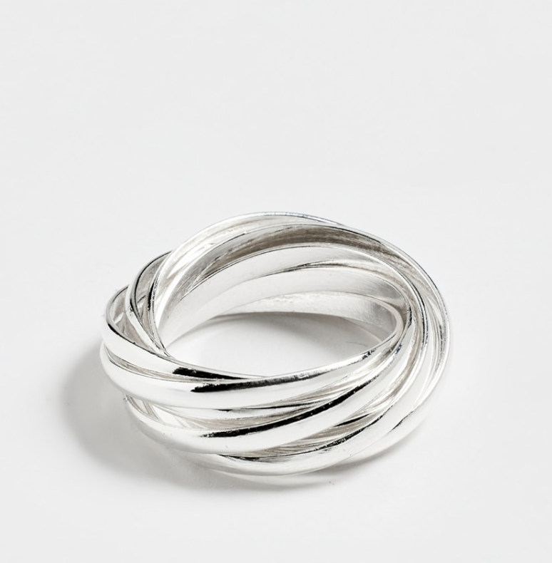 a silver set of rings in front of a plain backdrop
