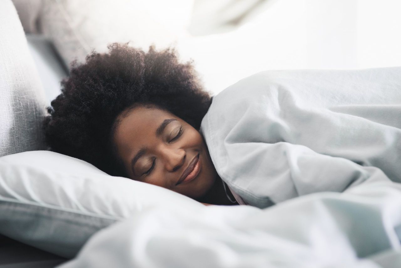 woman asleep under Aldi weighted blanket