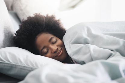 woman asleep under Aldi weighted blanket