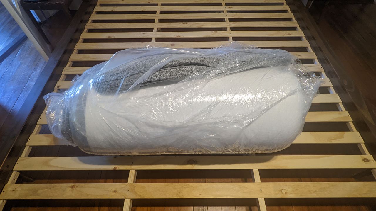 Ghostbed Luxe mattress rolled up, in plastic