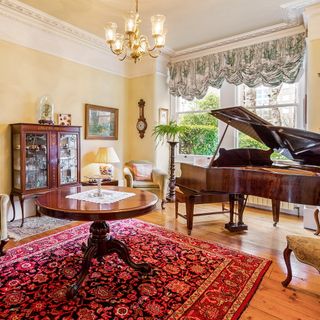 drawing room with wooden flooring and piano