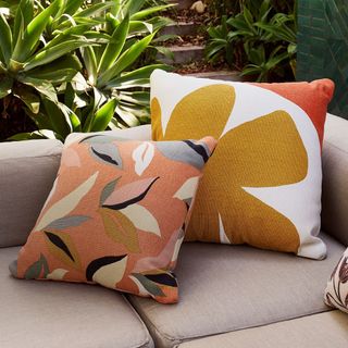 Coulouful outdoor cushions on a wicker sofa