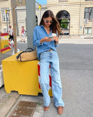 Woman in jeans and a denim shirt.