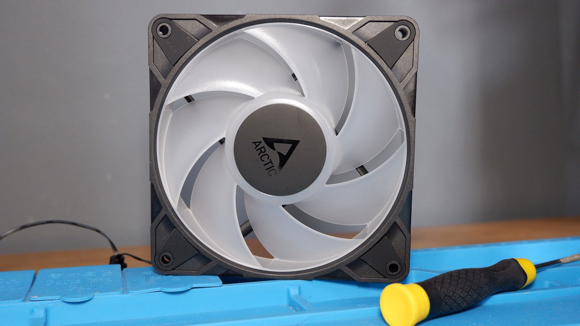 An Arctic P12 Pro fan on a soldering mat.