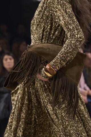 close up shot of model holding dark brown fringe bag at Isabel Marant F/W 24 runway