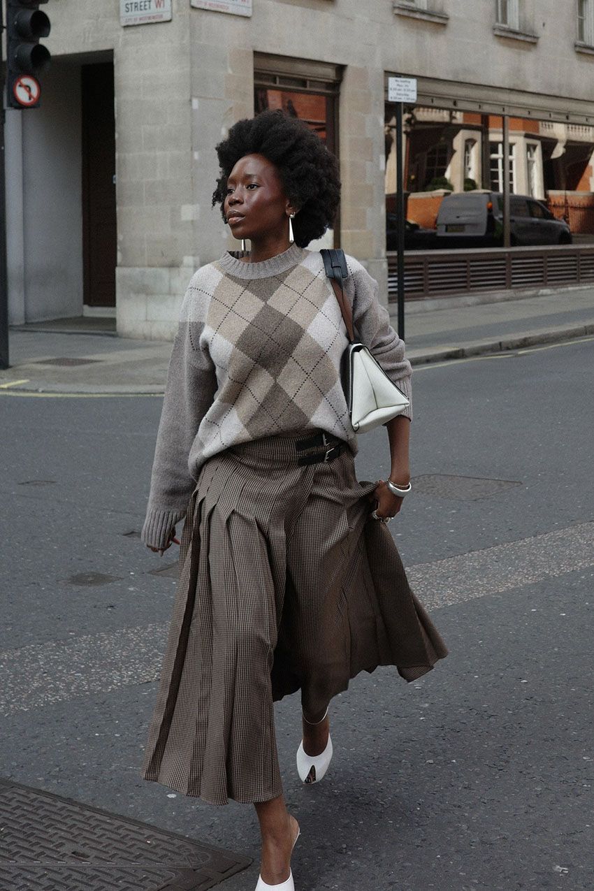 A woman wearing an argyle sweater.