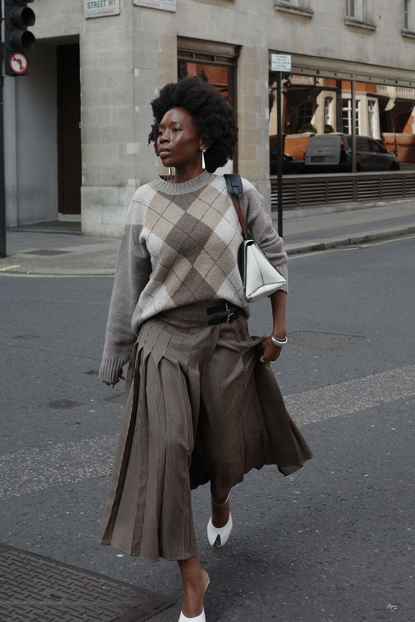 A woman wearing an argyle sweater.