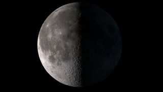 The half-illuminated moon as it appears during the first quarter moon. 