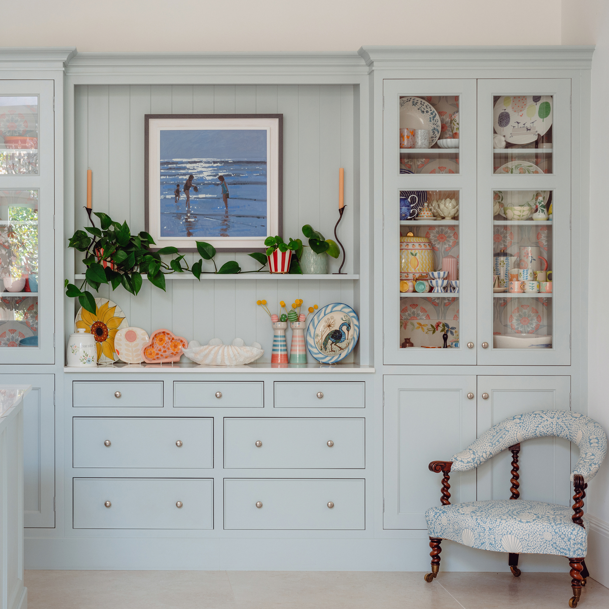 pale blue part glazed kitchen cabinets with wallpapered cabinet backs