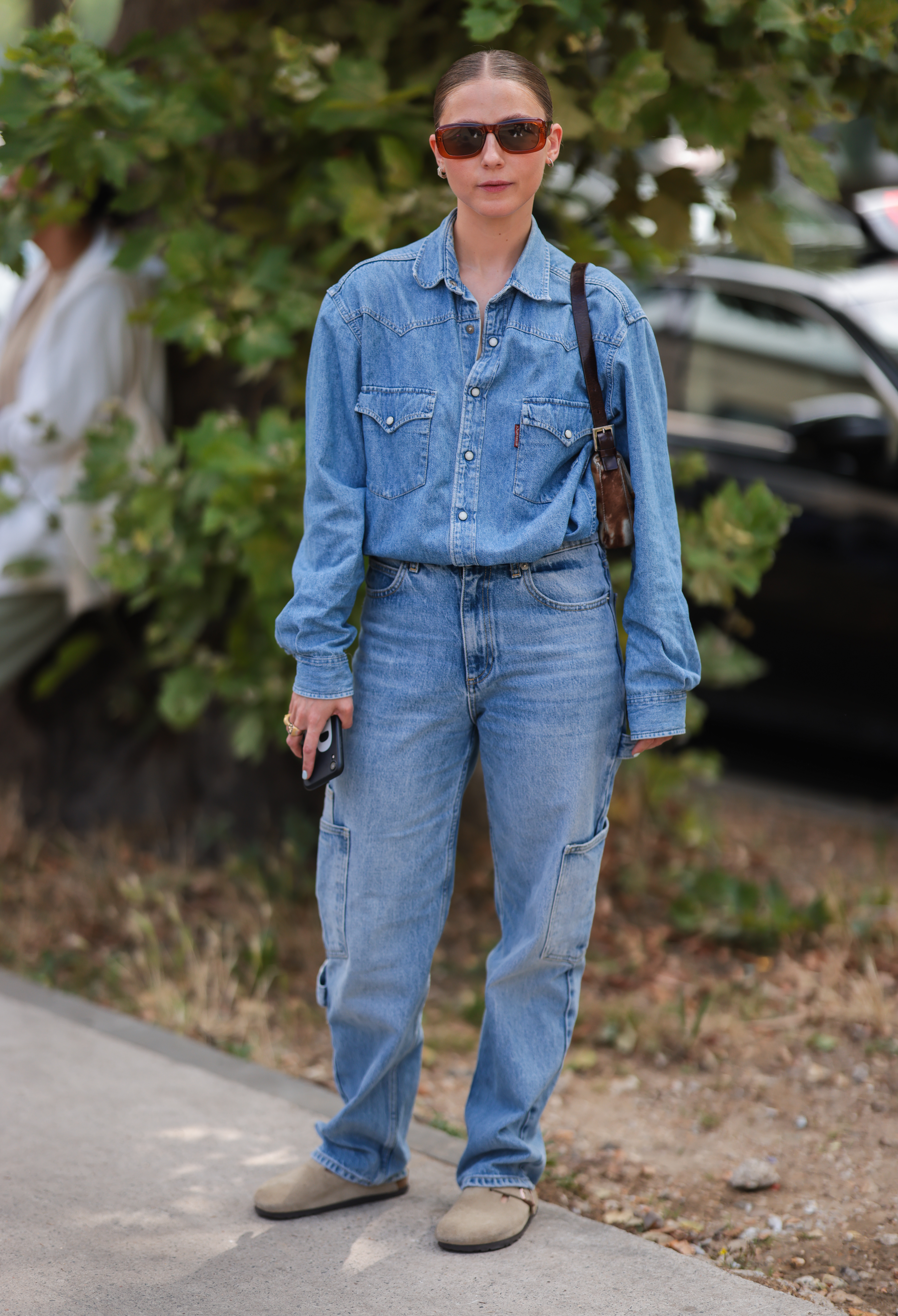Woman wearing a double denim outfit with Birkenstock clogs