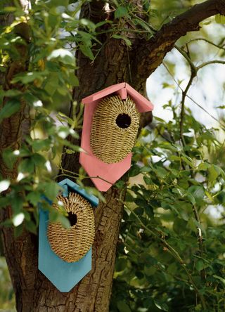 two bird houses painted in the brighter colours