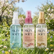 Image of three Avon Skin So Soft bottles in field of flowers