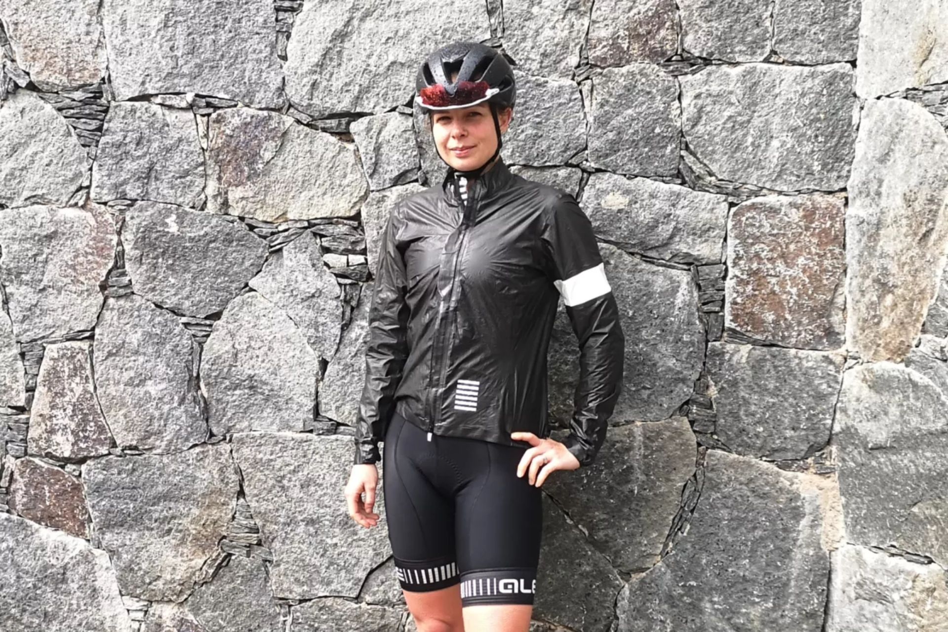 Image shows a rider wearing the Rapha Pro Team Lightweight Gore-Tex Jacket.