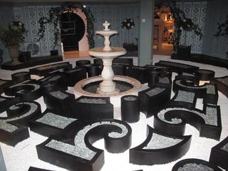 A reconstruction of the monochrome camellia garden setting - featured in the Chanel S/S 2011 runway show - waits