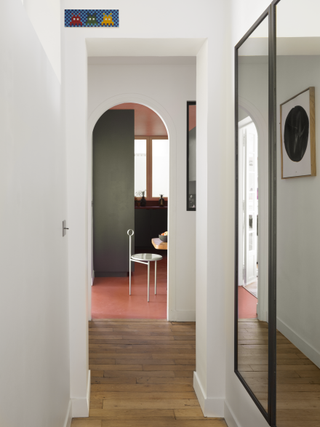 A gallery with salmon pink floor and grey cabinets
