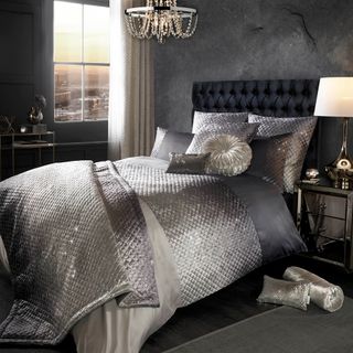bedroom with sophisticated gia bedding and candelier