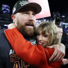 Travis Kelce and Taylor Swift hug after Kansas City Chiefs AFC Championship win in 2024.