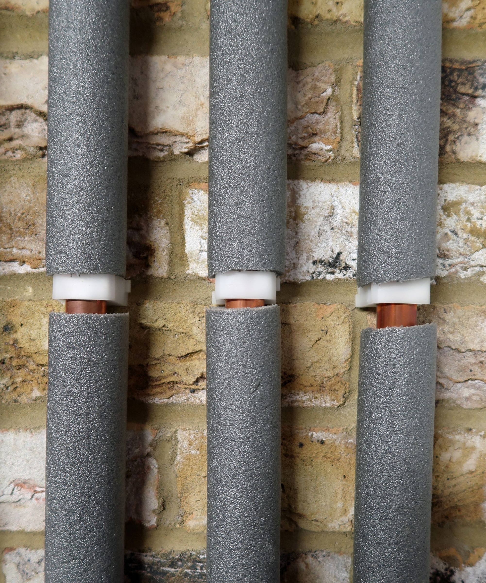 Three copper pipes with insulation wrapped around them