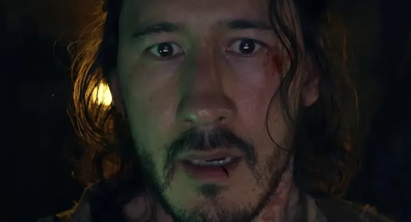 A close up of Markiplier in Iron Lung, looking scared