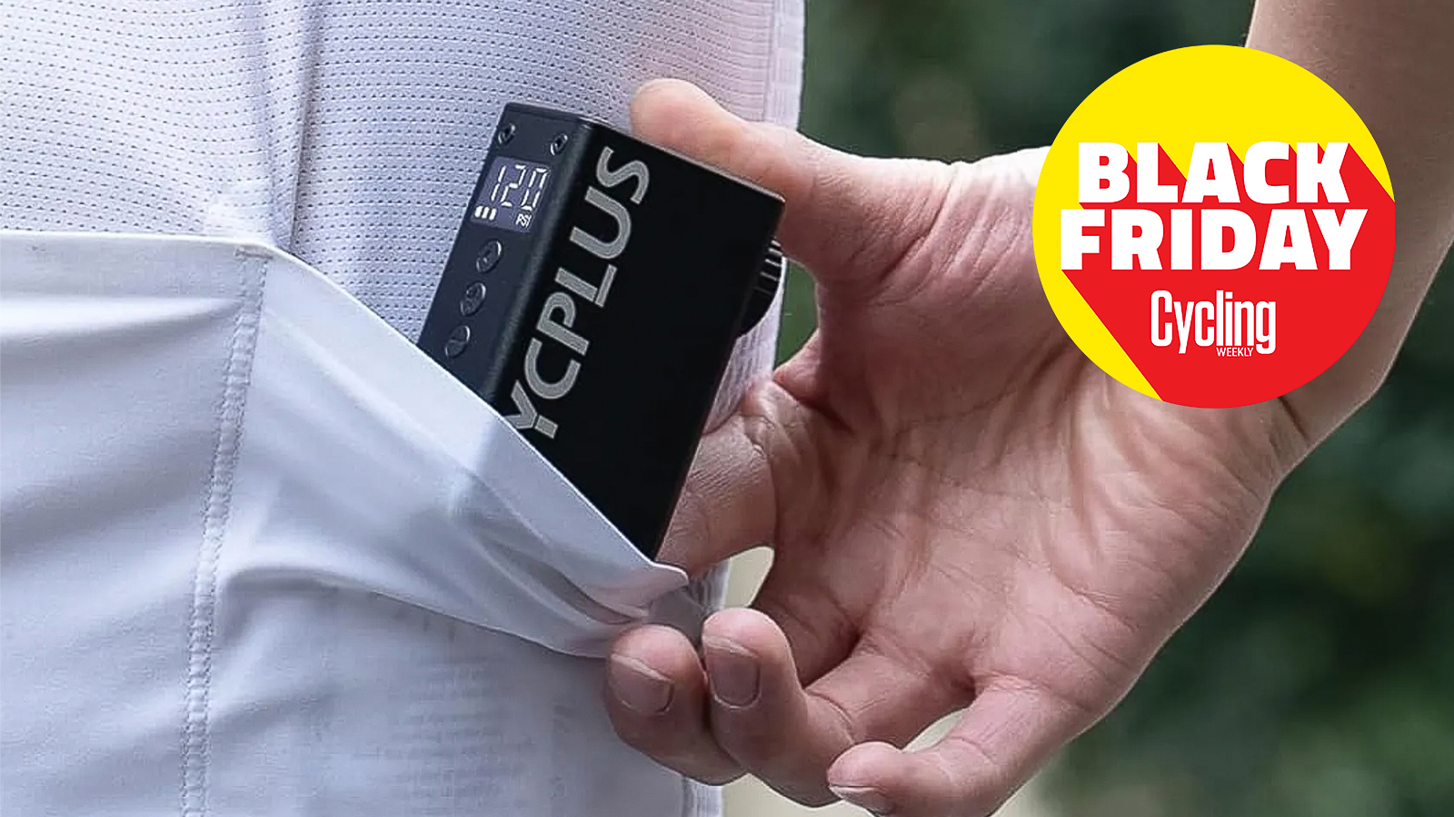 The Cycplus AS2 Pro being slipped into a cycling jersey pocket, showing its compact sizing with the Black Friday 2025 Cycling Weekly logo.
