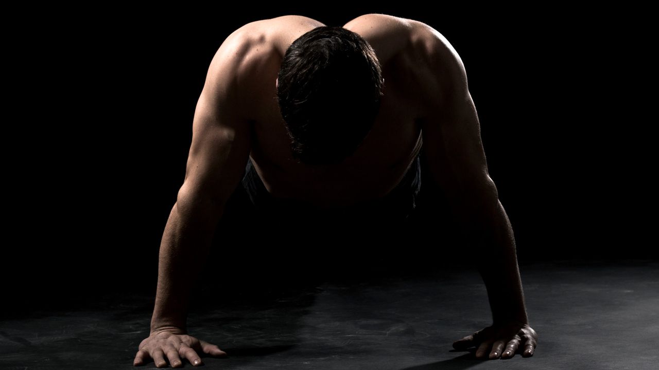 A muscular man doing push ups